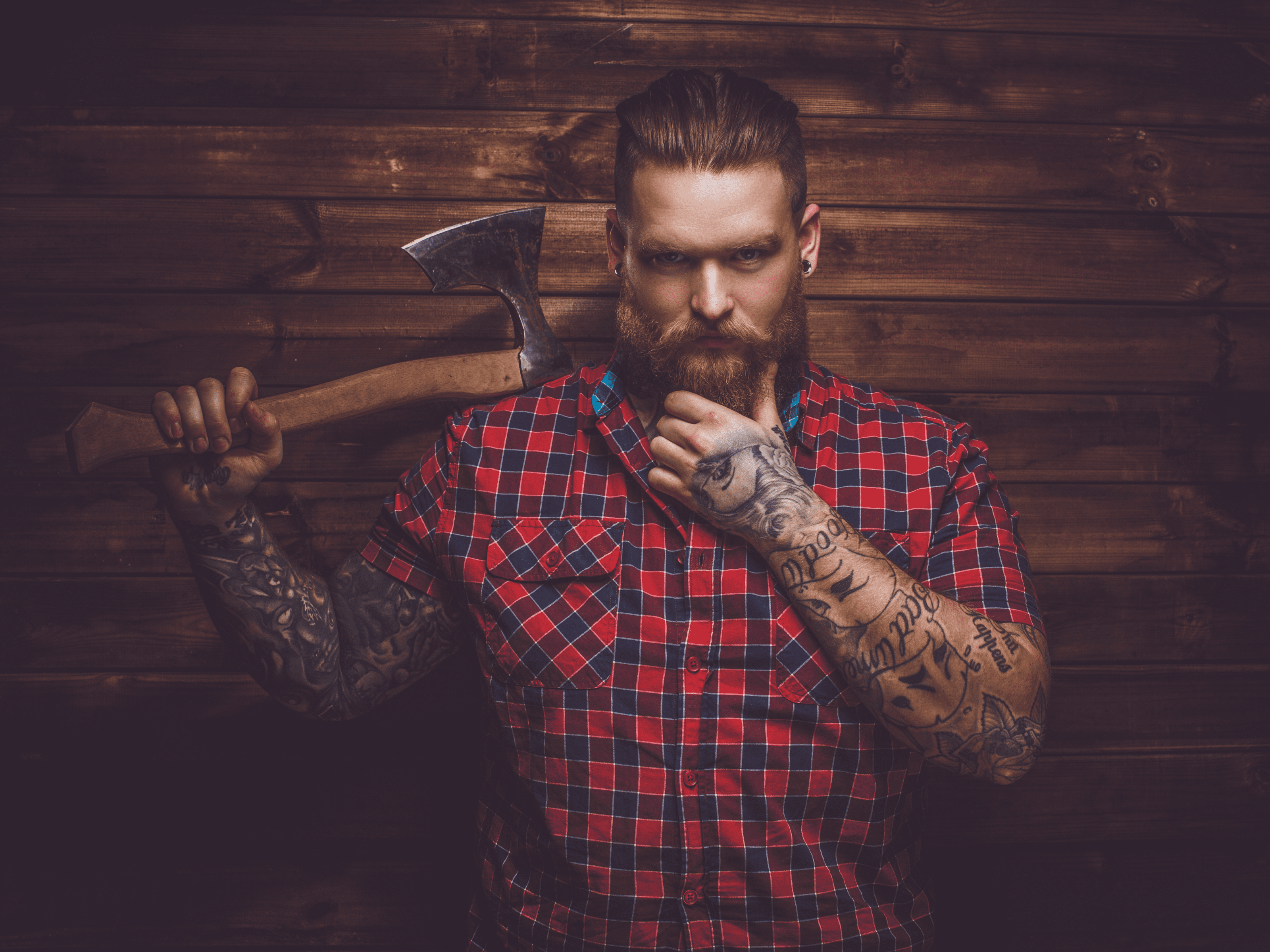 man with beard holding axe
