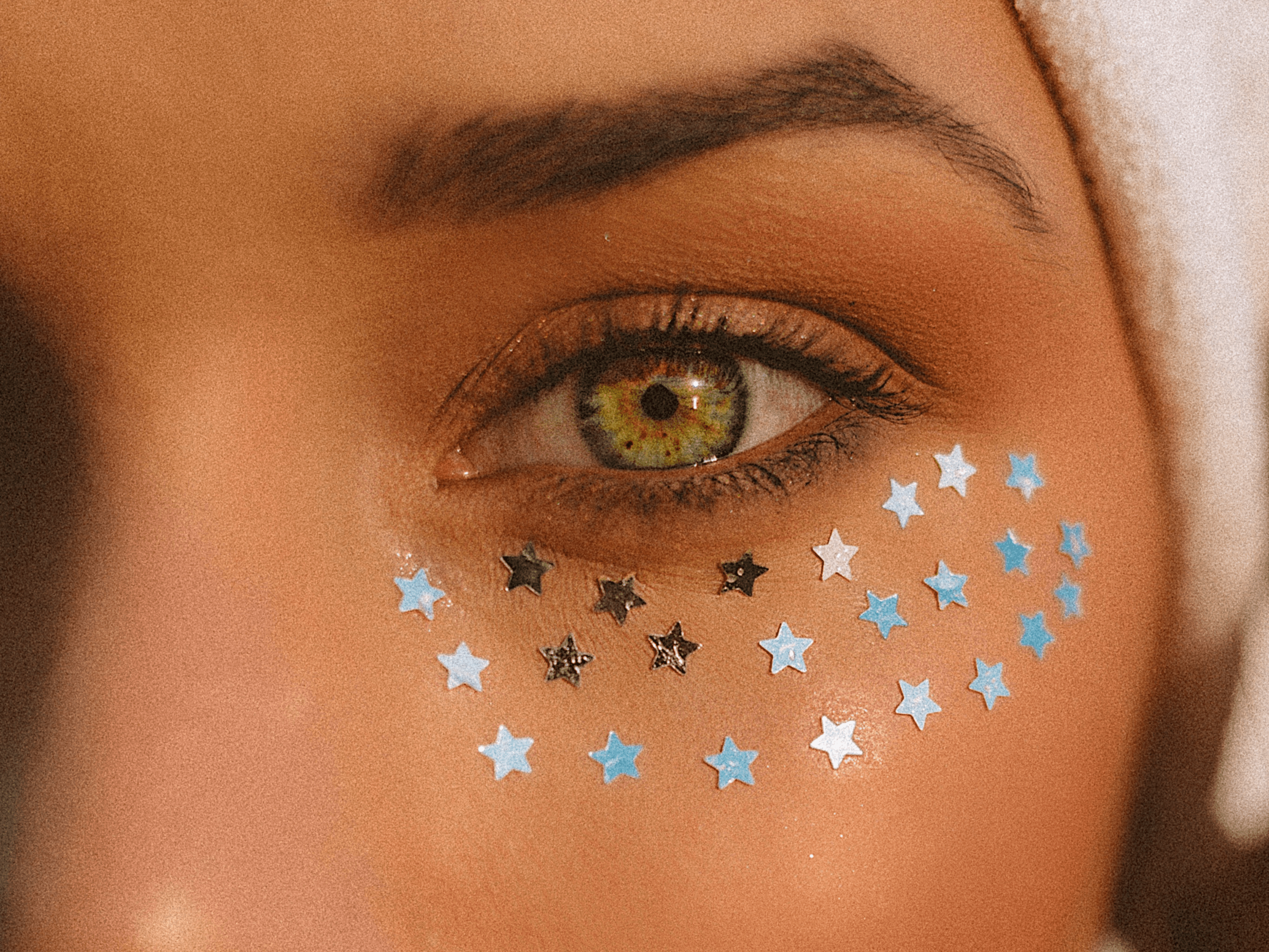 woman with glitter under her eye