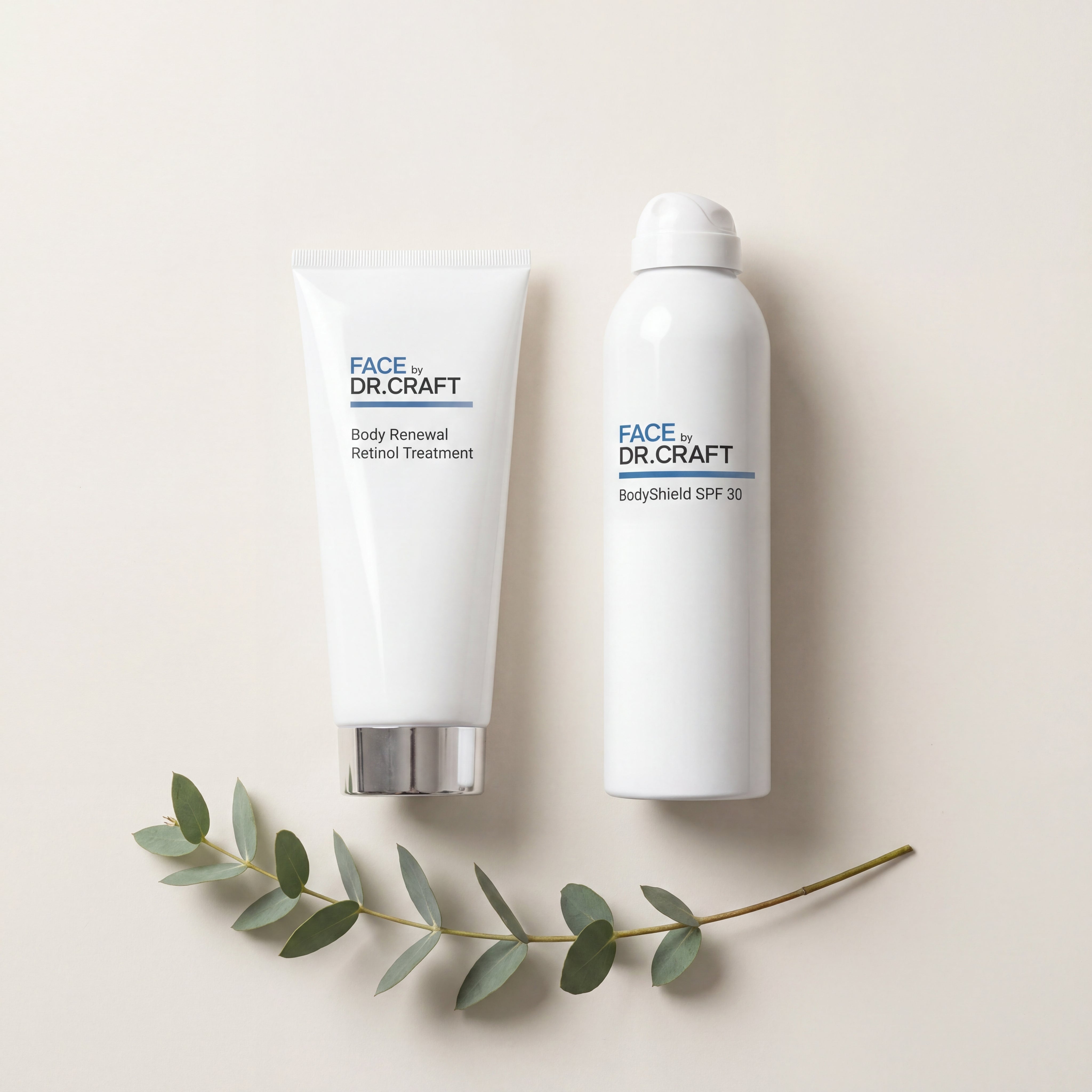 Flat lay of the two FACE by Dr. Craft products in the Body Renewal System — Body Renewal Retinol Treatment and BodyShield SPF 30 — on a warm bone background.